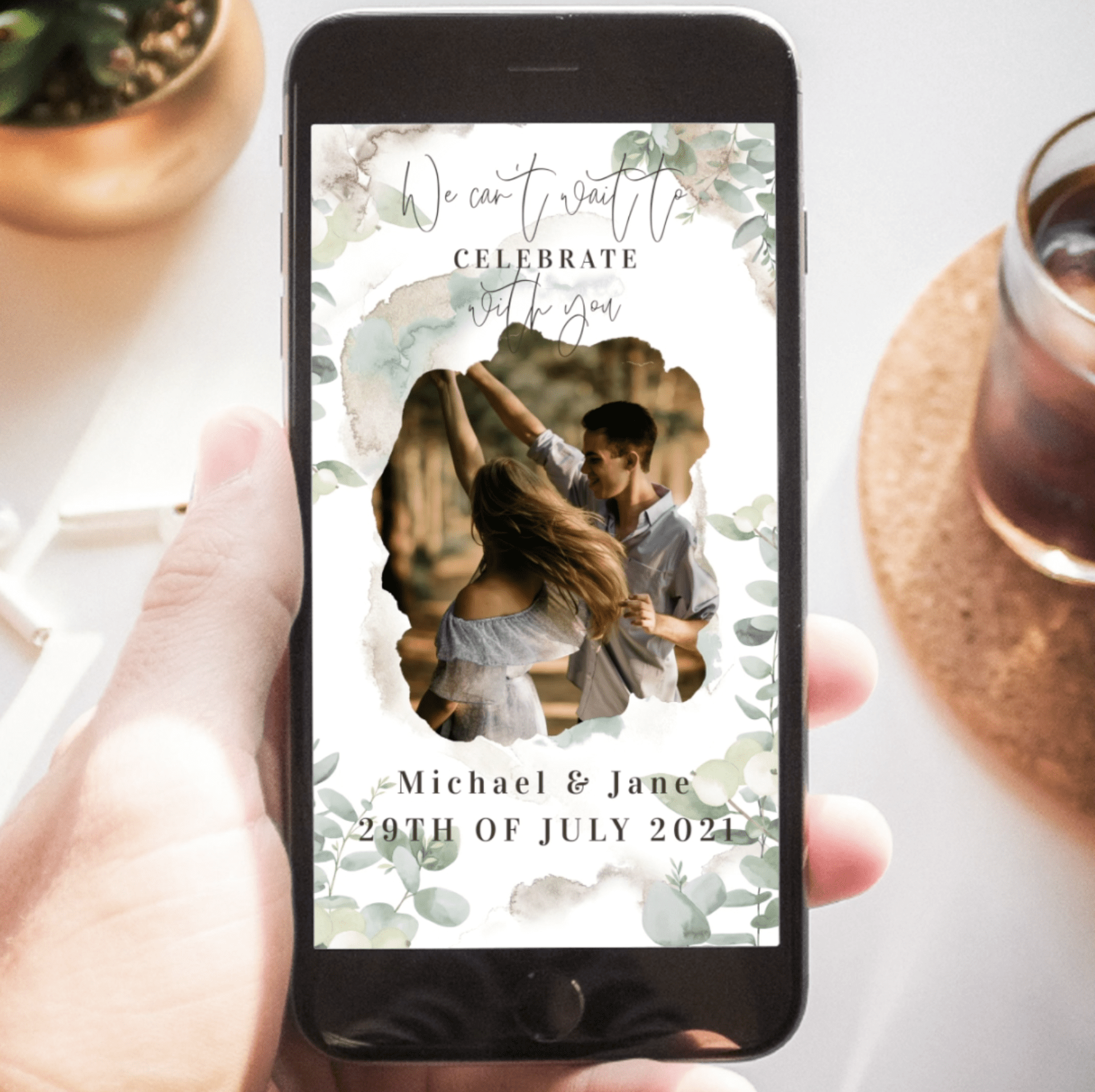 Save the Date delight playing on phone, held in a hand